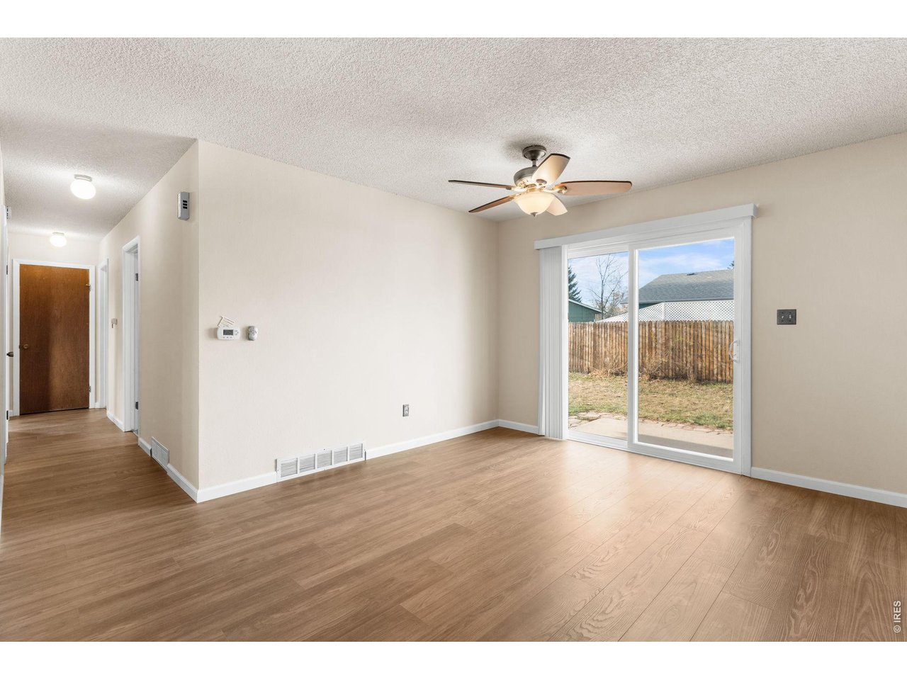2912 Radcliff Circle Fort Collins, CO 80521 - Photo 17 of 46 a view of an empty room with wooden floor