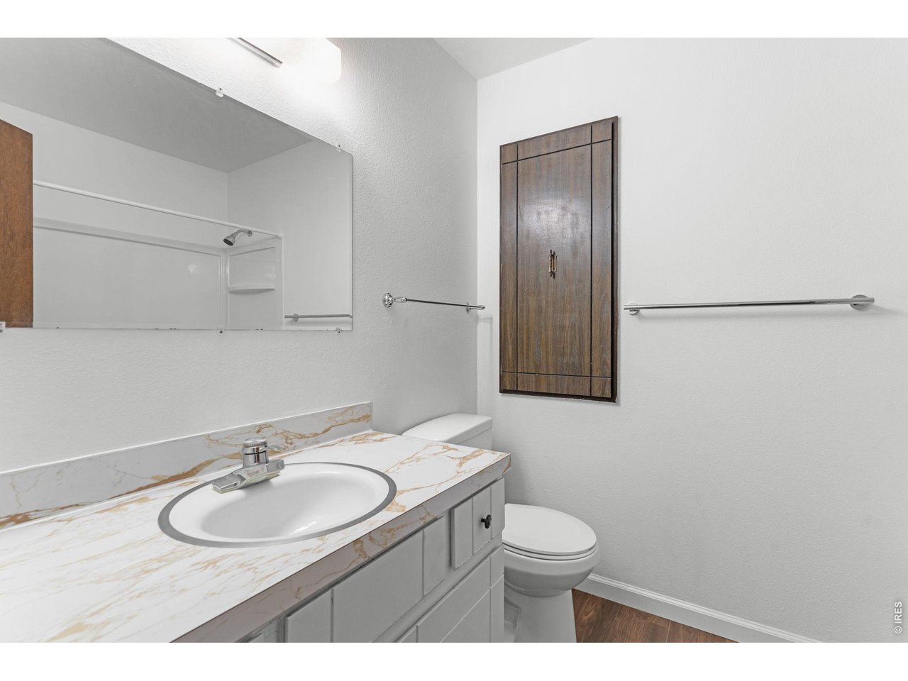 2912 Radcliff Circle Fort Collins, CO 80521 - Photo 23 of 46 a bathroom with a toilet sink a mirror and vanity