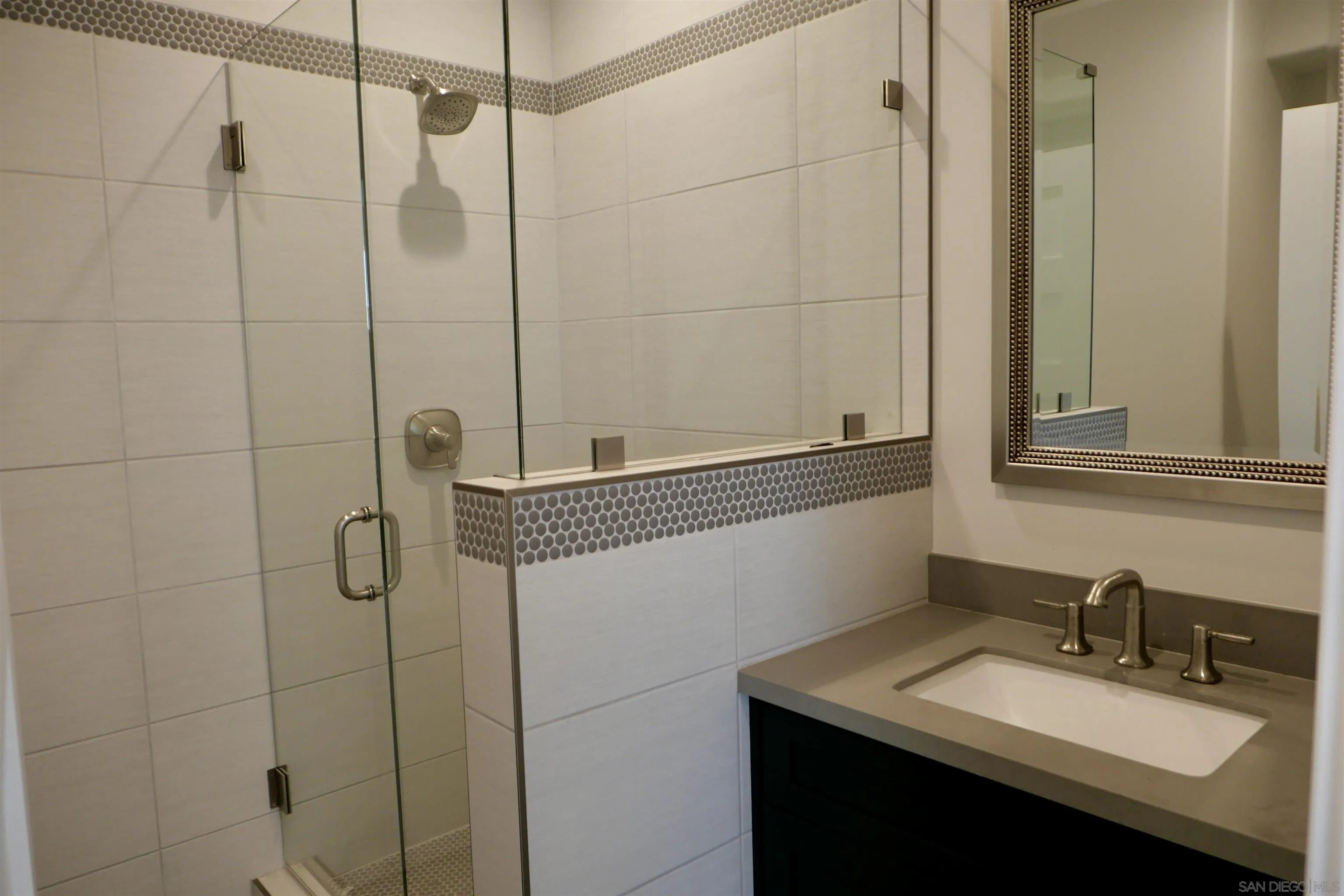 1776 Cable Street San Diego, CA 92107 - Photo 11 of 26 a bathroom with a granite countertop sink a mirror and shower