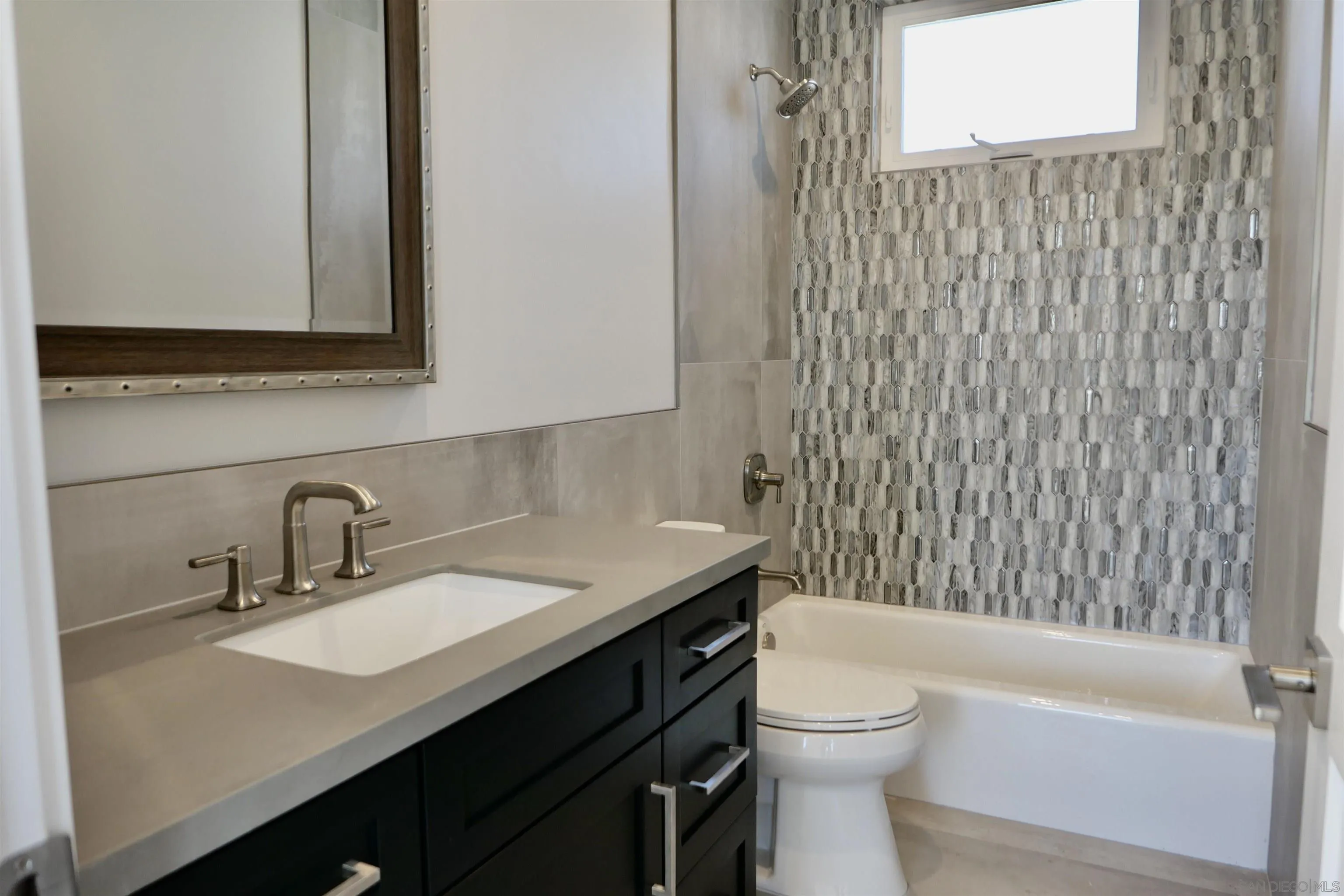 1776 Cable Street San Diego, CA 92107 - Photo 18 of 26 a bathroom with a sink a toilet and shower