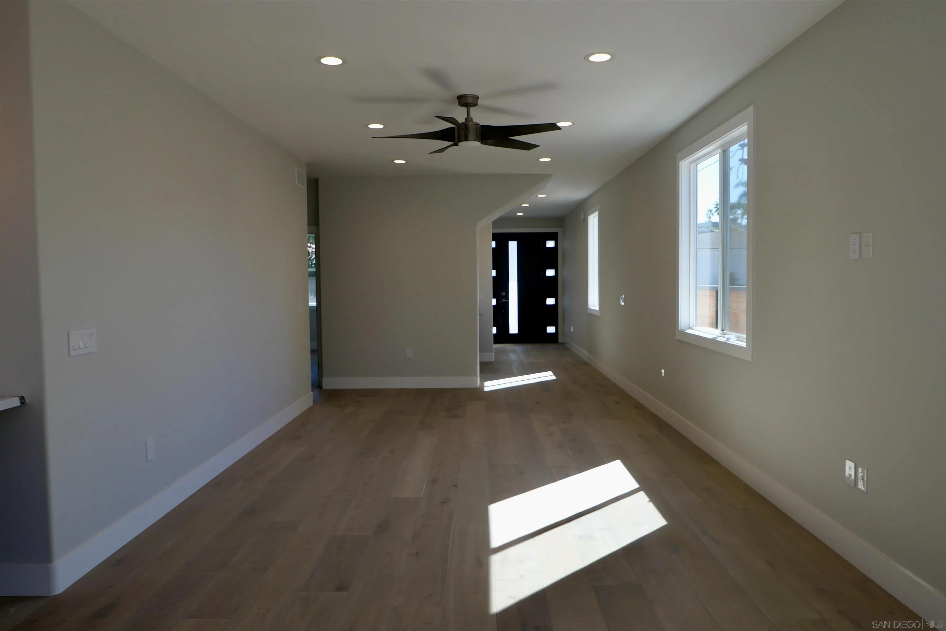 1776 Cable Street San Diego, CA 92107 - Photo 8 of 26 an empty room with windows and ceiling fan