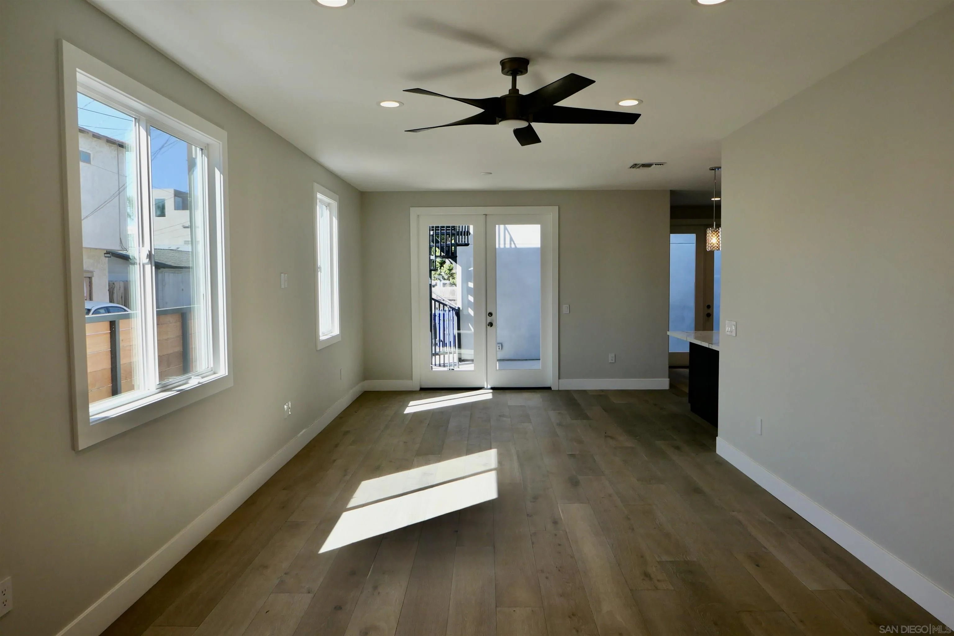 1776 Cable Street San Diego, CA 92107 - Photo 9 of 26 a view of empty room with wooden floor and fan