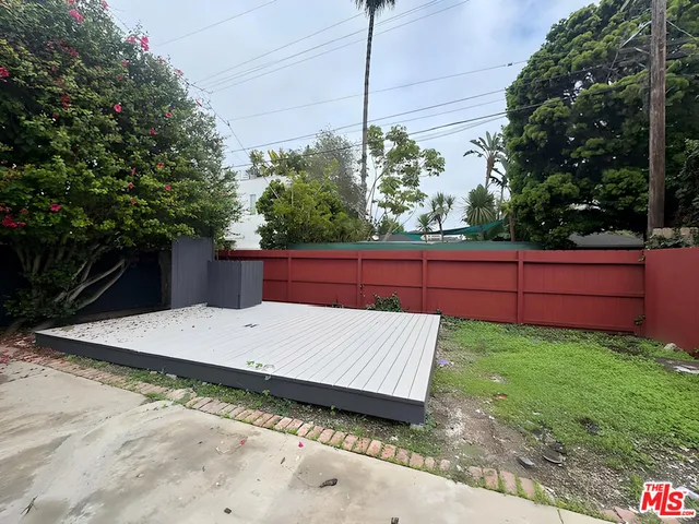 a view of a backyard with wooden fence