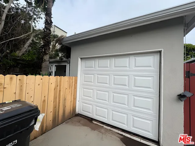 a view of small house with wooden fence