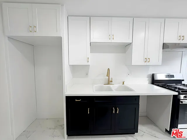 a kitchen with a sink and cabinets