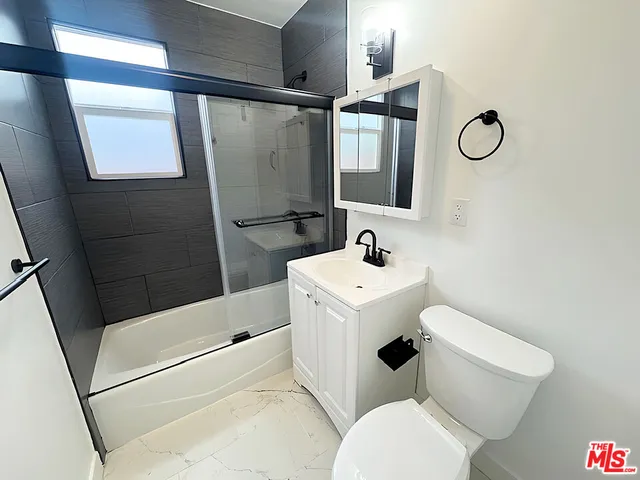 a bathroom with a toilet sink and shower