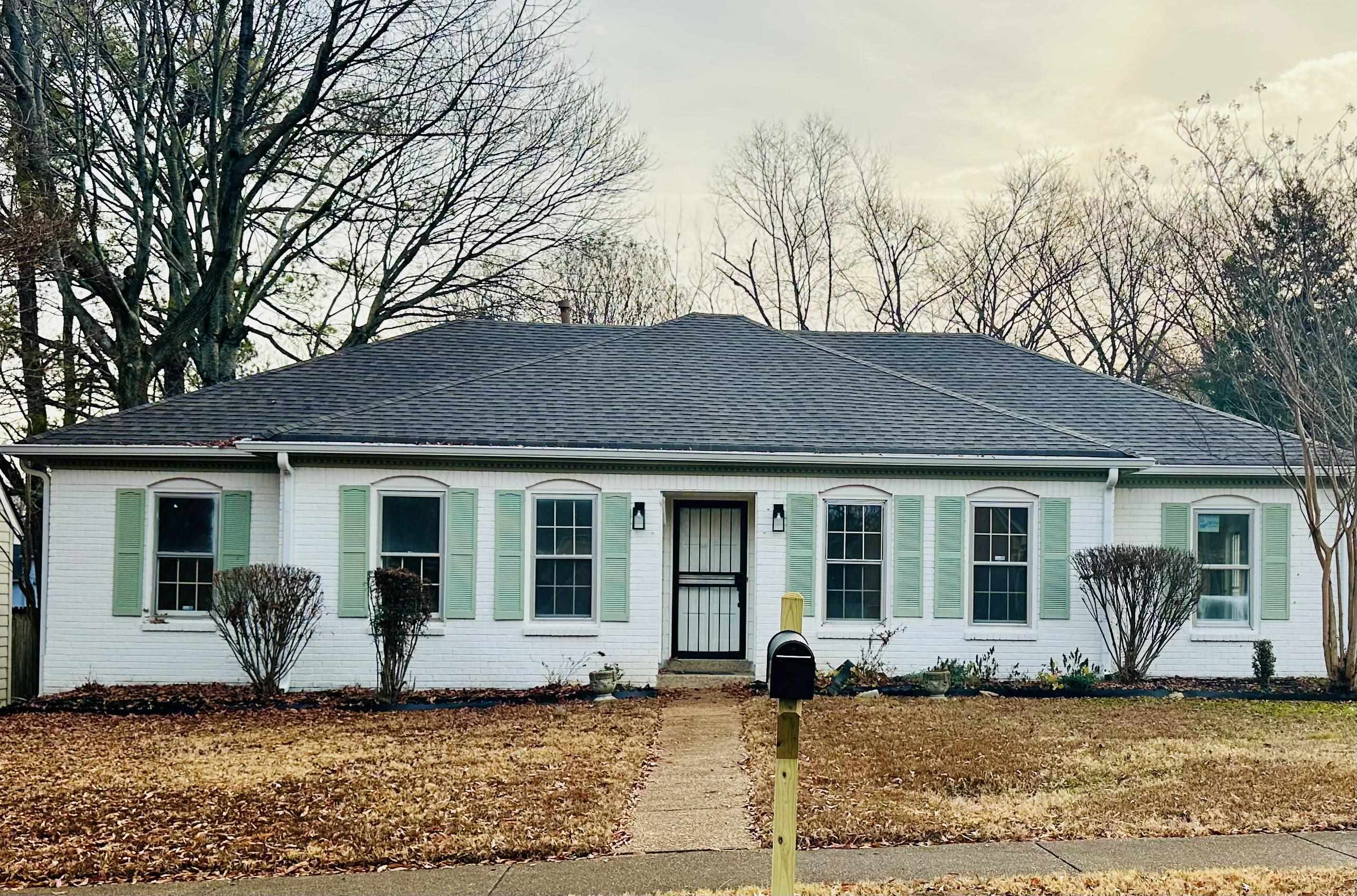 960 Hunters Point Memphis, TN 38018 - Photo 1 of 1 Ranch-style house featuring a shingled roof, brick siding, and a front lawn