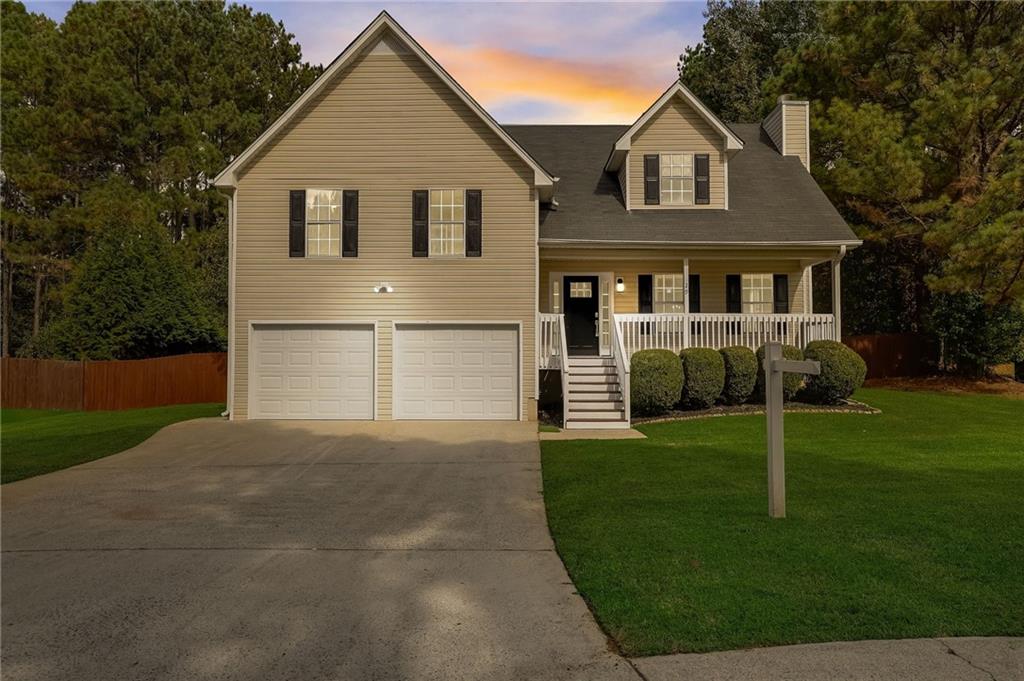 29 Thorntree Pass Powder Springs, GA 30127 - Photo 1 of 1 View of front of home with a garage, covered porch, and a lawn