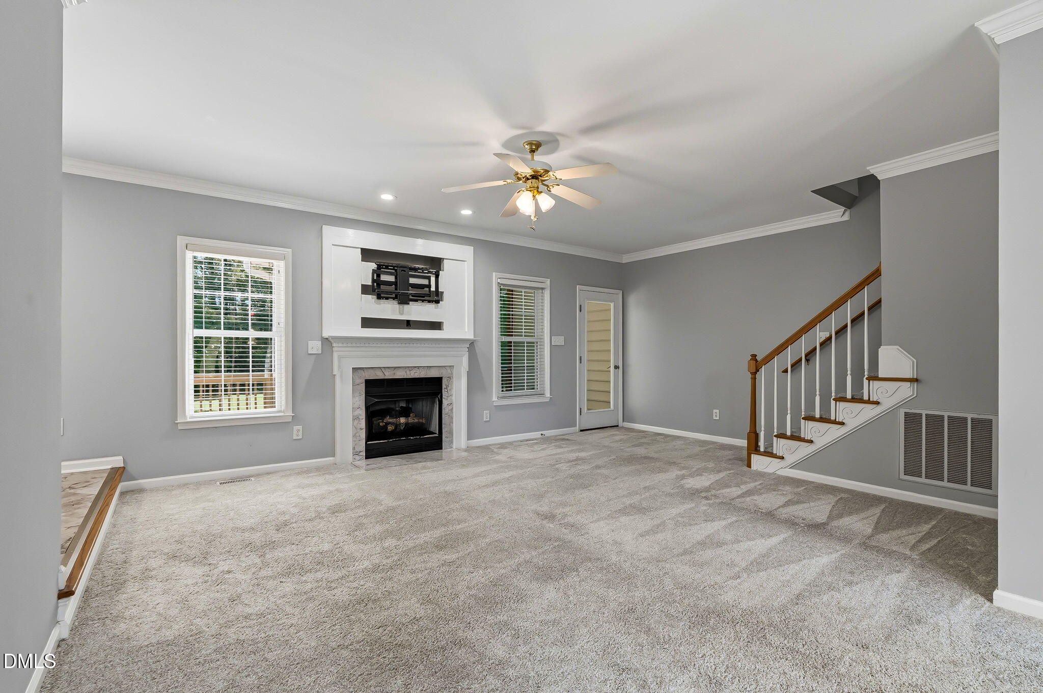 1112 Tyler Farms Drive Raleigh, NC 27603 - Photo 13 of 78 a view of a livingroom with a fireplace a ceiling fan and windows