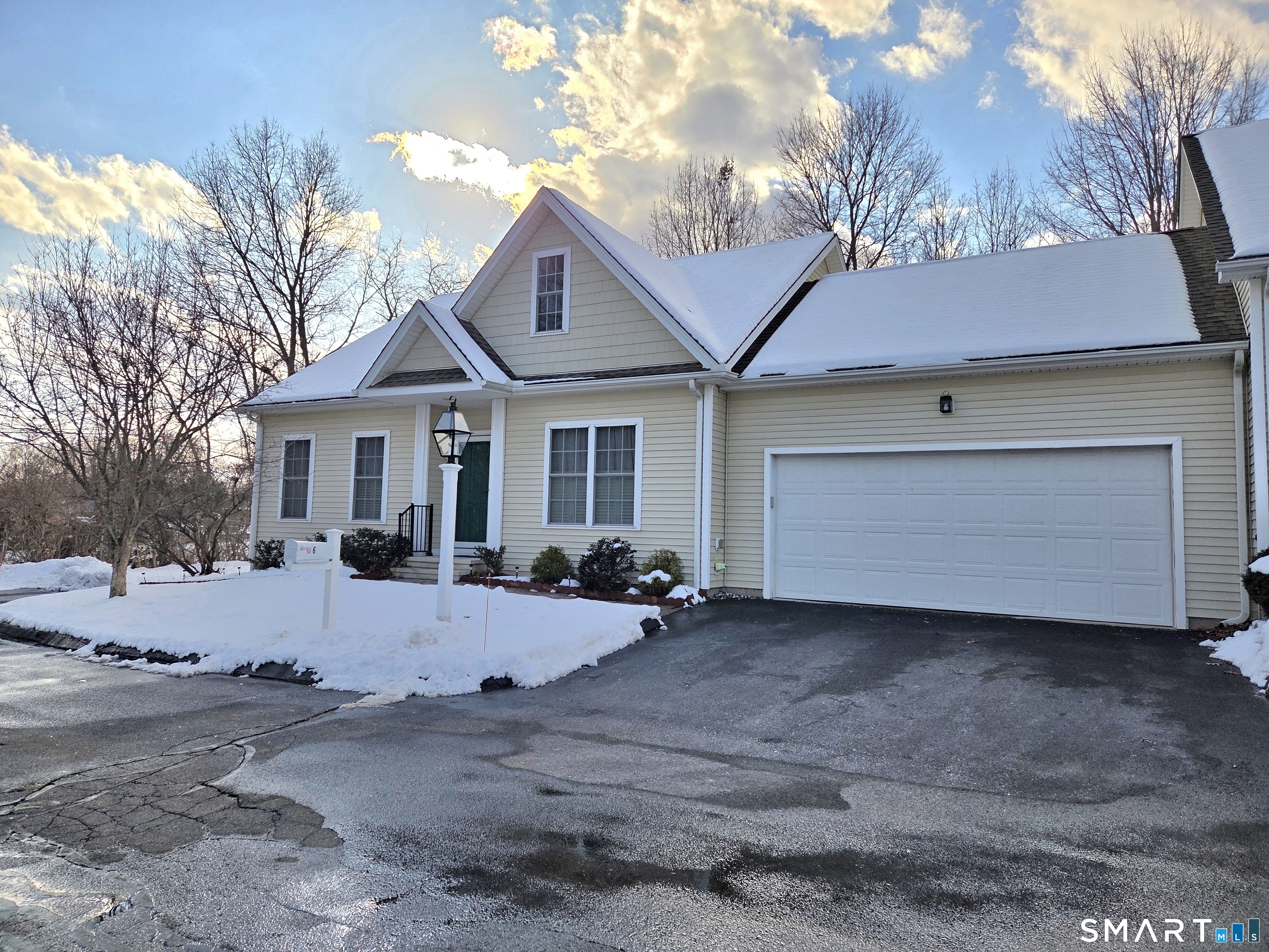6 Whitman Lane, Unit 6 Vernon, CT 06066 - Photo 2 of 28 a view of a house with a yard covered in snow