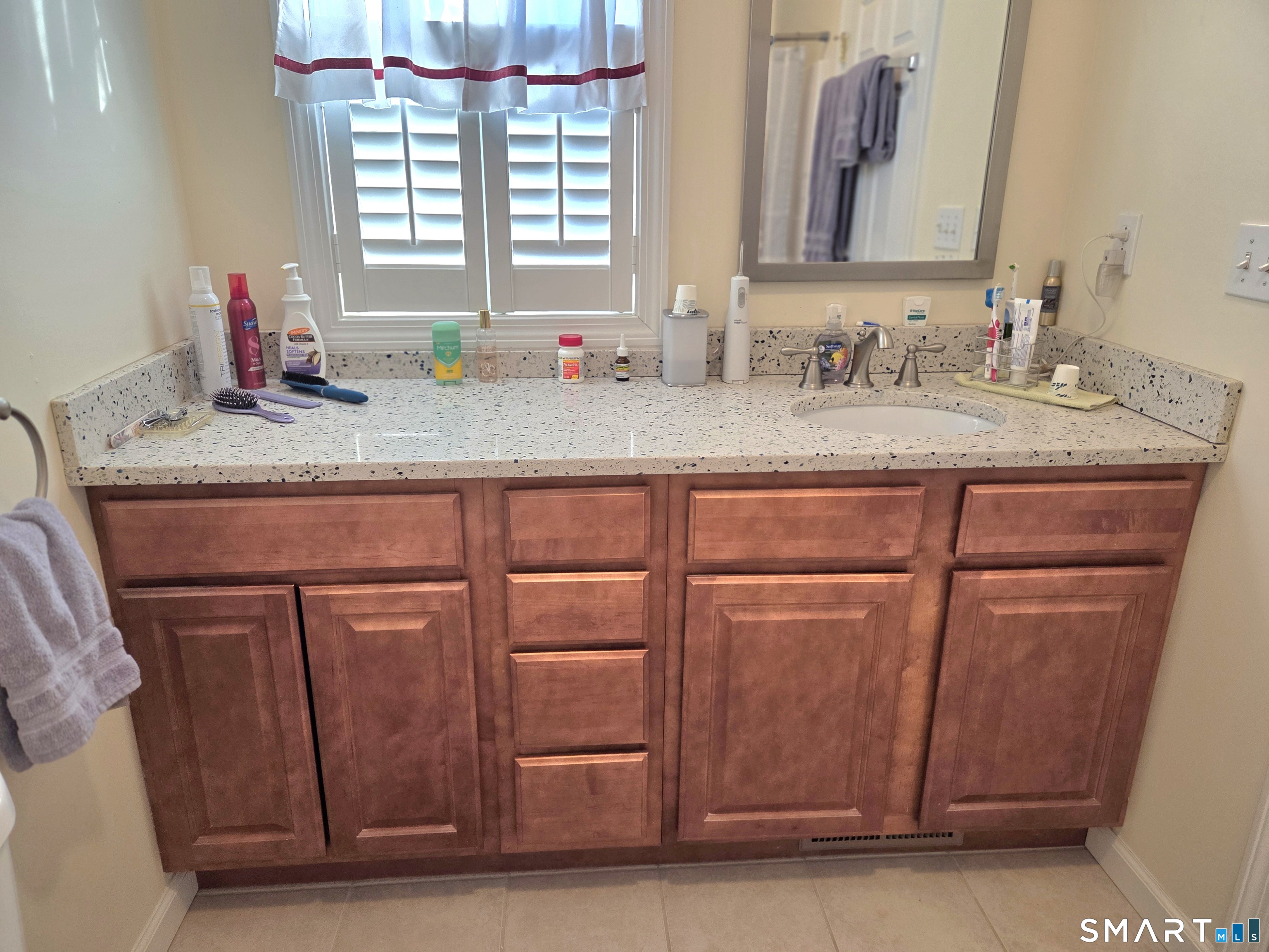6 Whitman Lane, Unit 6 Vernon, CT 06066 - Photo 21 of 28 a bathroom with a granite countertop sink and a mirror