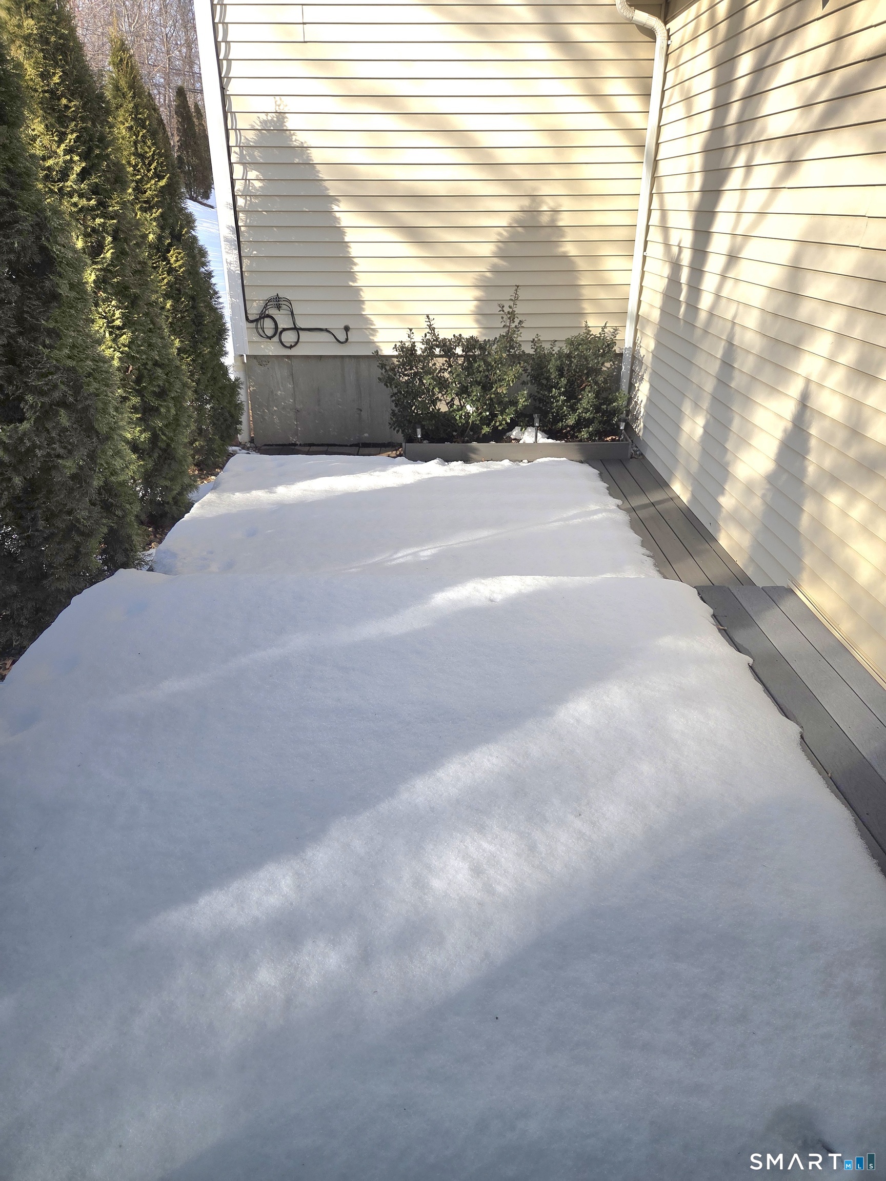 6 Whitman Lane, Unit 6 Vernon, CT 06066 - Photo 23 of 28 a side view of a house with a yard and garage