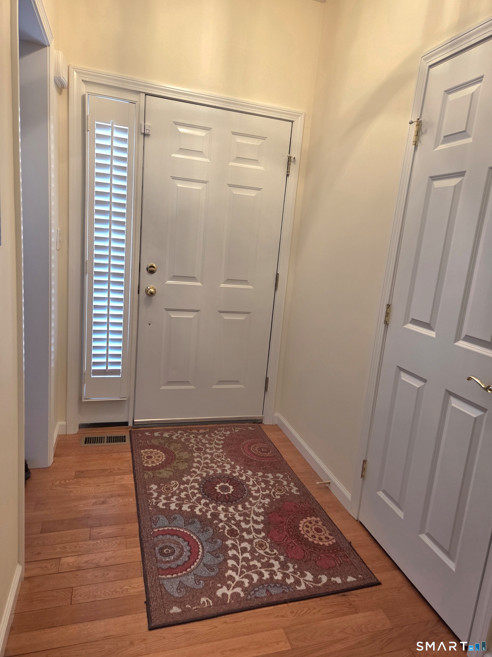 6 Whitman Lane, Unit 6 Vernon, CT 06066 - Photo 4 of 28 an empty room with wooden floor and windows