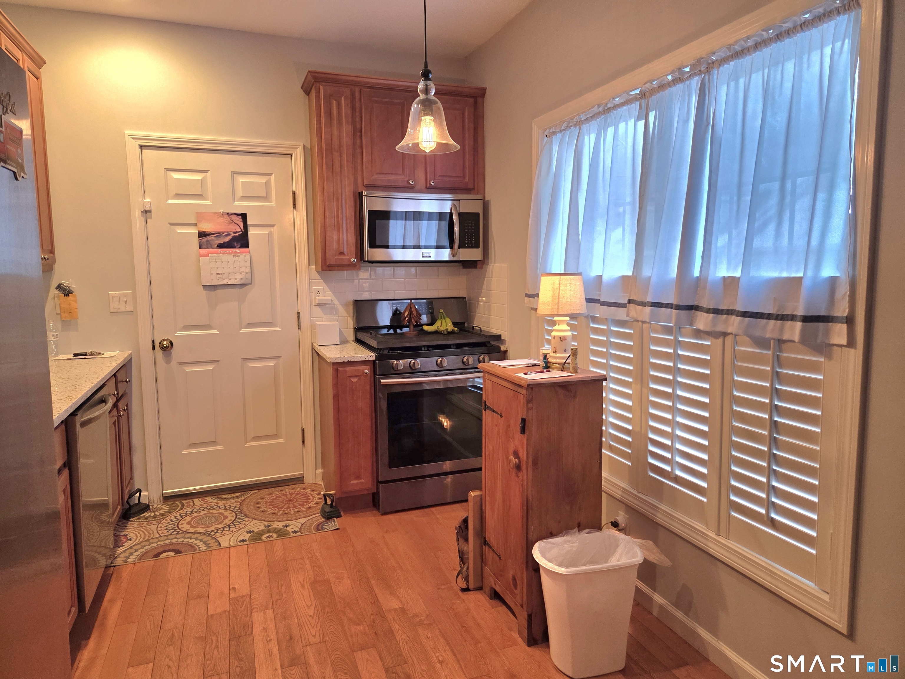 6 Whitman Lane, Unit 6 Vernon, CT 06066 - Photo 5 of 28 a kitchen with stainless steel appliances a stove a refrigerator and cabinets