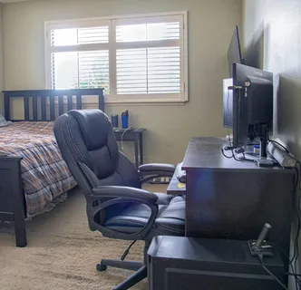 a bedroom with furniture and a window