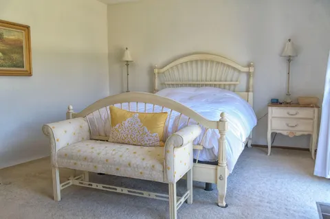 a bedroom with a bed and a table