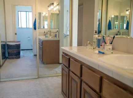 a bathroom with a sink double vanity and a mirror