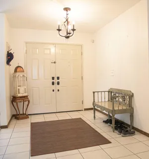 a view of a hallway with wooden floor and dining room view