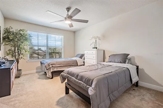 a living room with large windows and a table