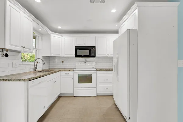 a kitchen with a sink stove and microwave