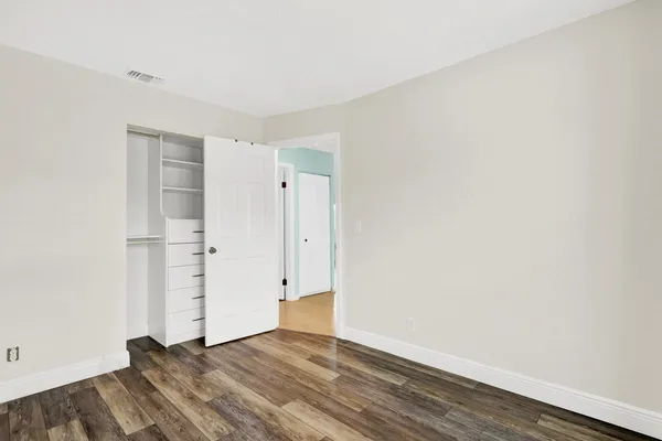 an empty room with wooden floor