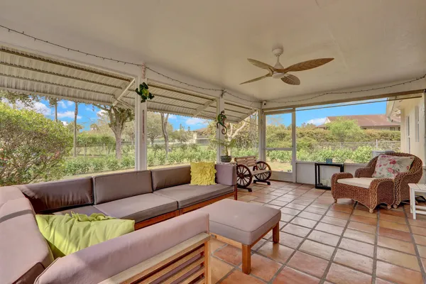 a living room with furniture and a floor to ceiling window