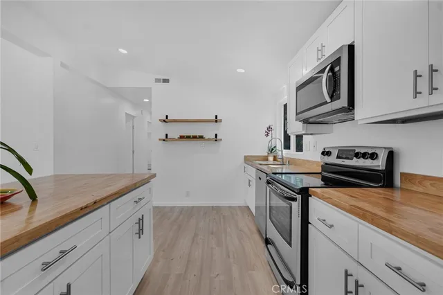 a view of kitchen with sink and window
