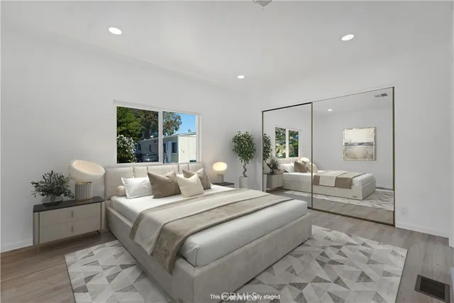 a bathroom with a granite countertop sink mirror vanity and toilet