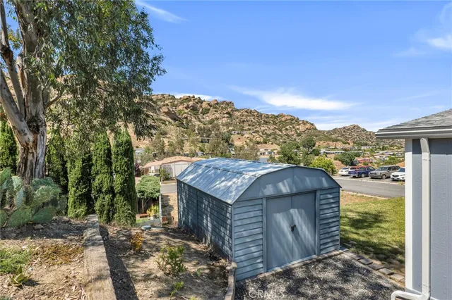 a view of a house with a small yard and wooden fence