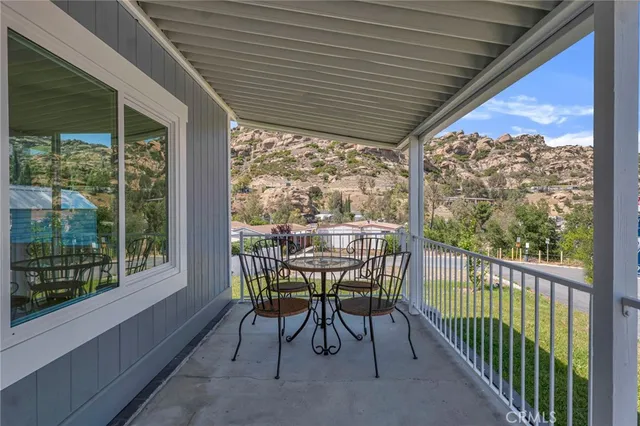 a view of a porch with furniture and wooden floor