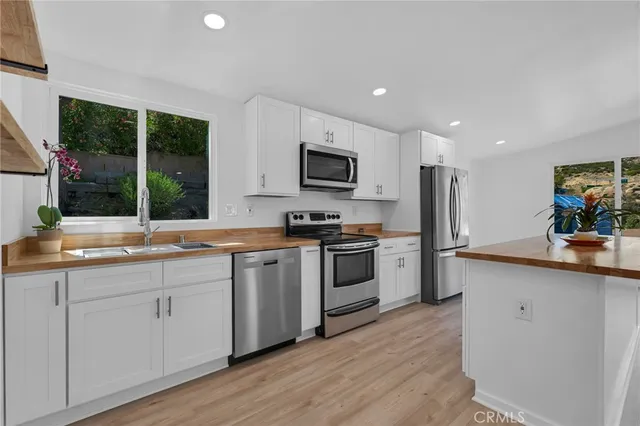 a kitchen with stainless steel appliances a sink and a stove