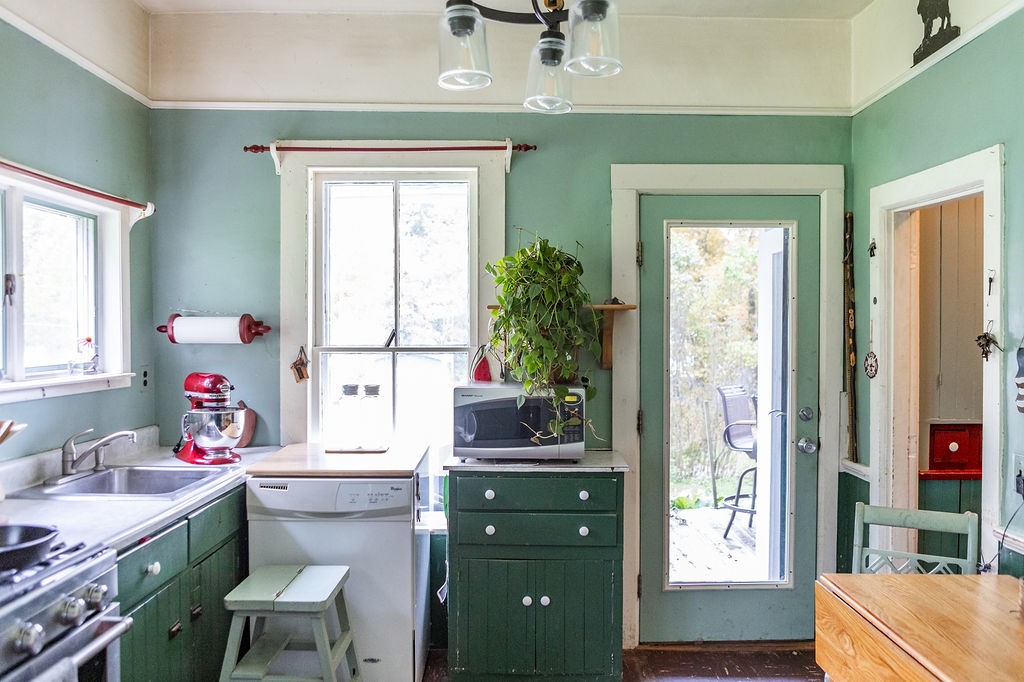 67 Fisk Road Bovina, NY 13753 - Photo 7 of 48 A glass exterior door opens directly to the side deck from this classic kitchen.