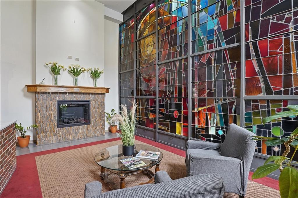 5 Bayard Road, Unit 309 Pittsburgh, PA 15213 - Photo 3 of 42 Elegant fireside lounge welcomes residents home in style, beneath soaring ceilings and vibrant stained glass.