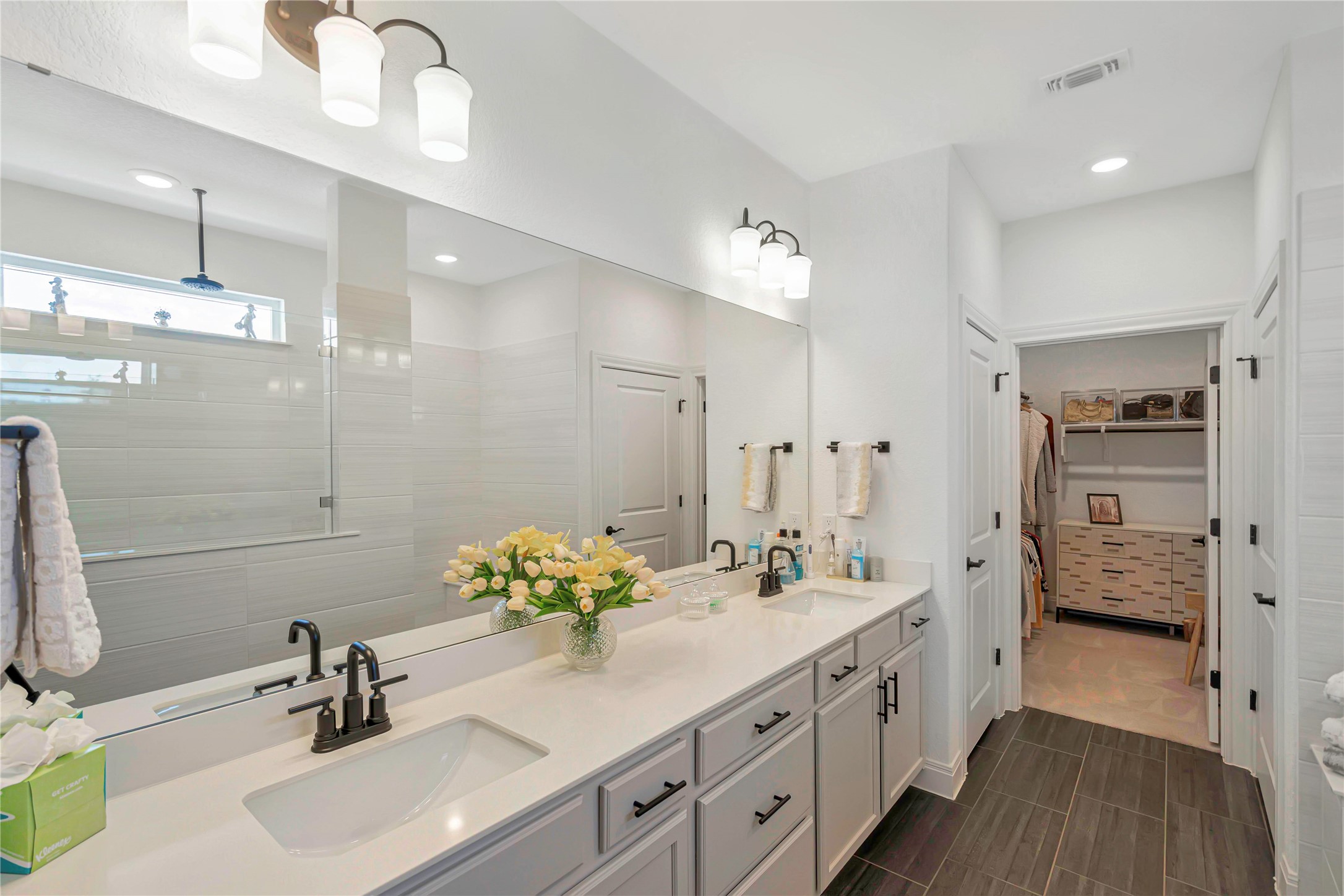 126 Lafayette Street Georgetown, TX 78633 - Photo 17 of 30 a bathroom with a double vanity sink a mirror and a shower