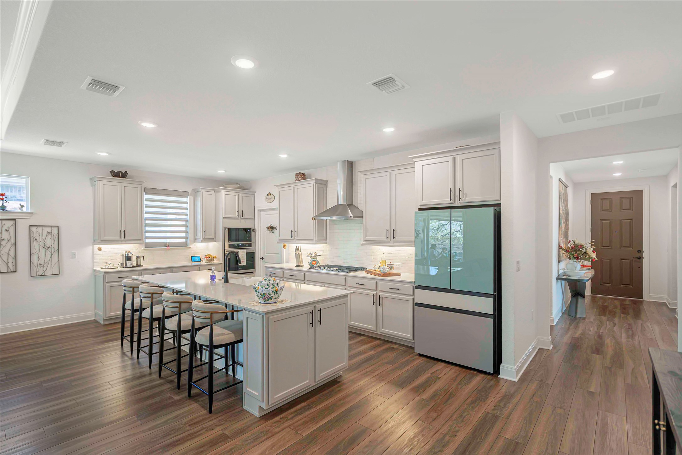 126 Lafayette Street Georgetown, TX 78633 - Photo 6 of 30 a kitchen with a sink a stove a refrigerator and island with wooden floor