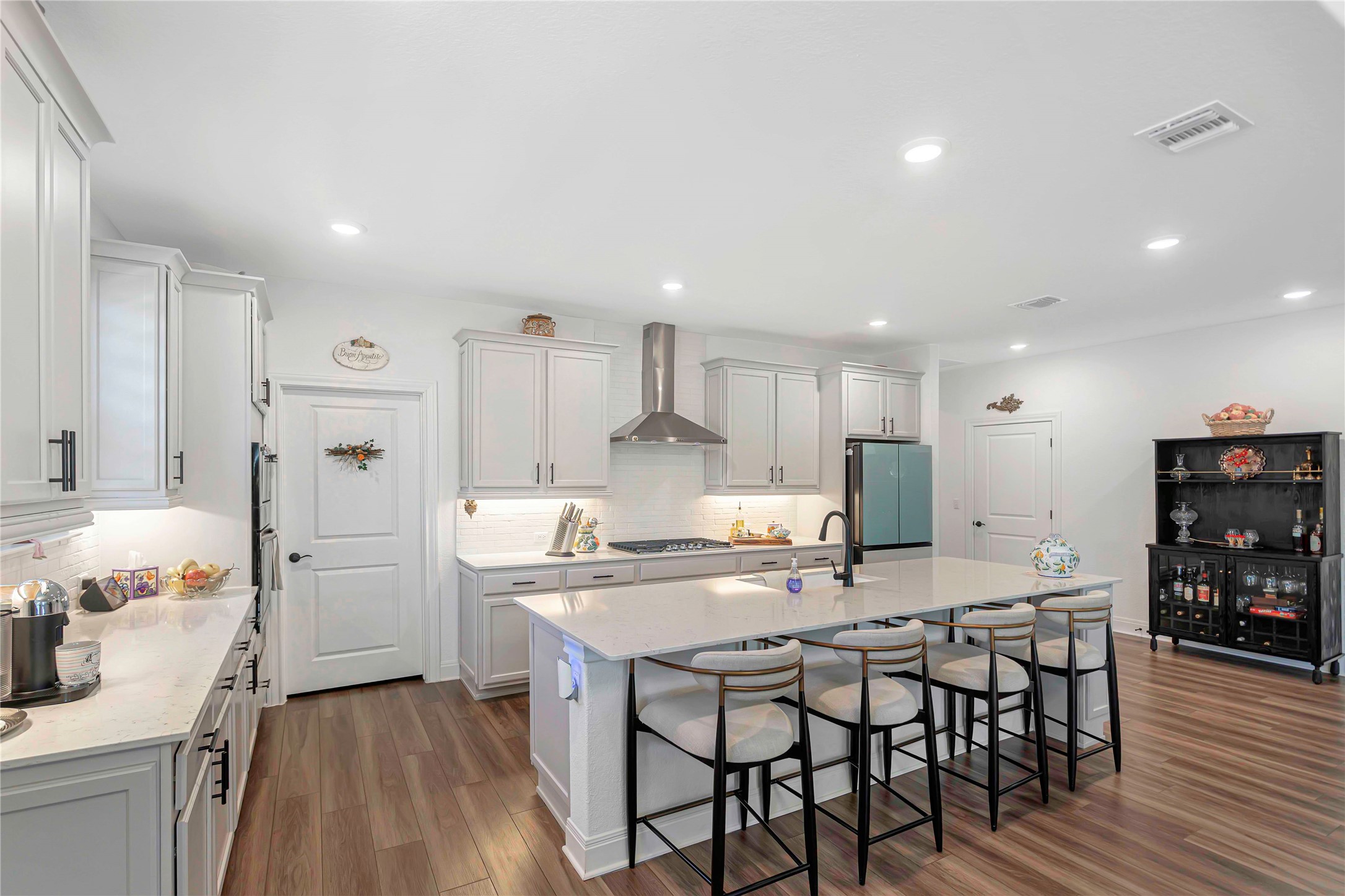 126 Lafayette Street Georgetown, TX 78633 - Photo 7 of 30 a kitchen with stainless steel appliances a dining table chairs stove refrigerator and cabinets