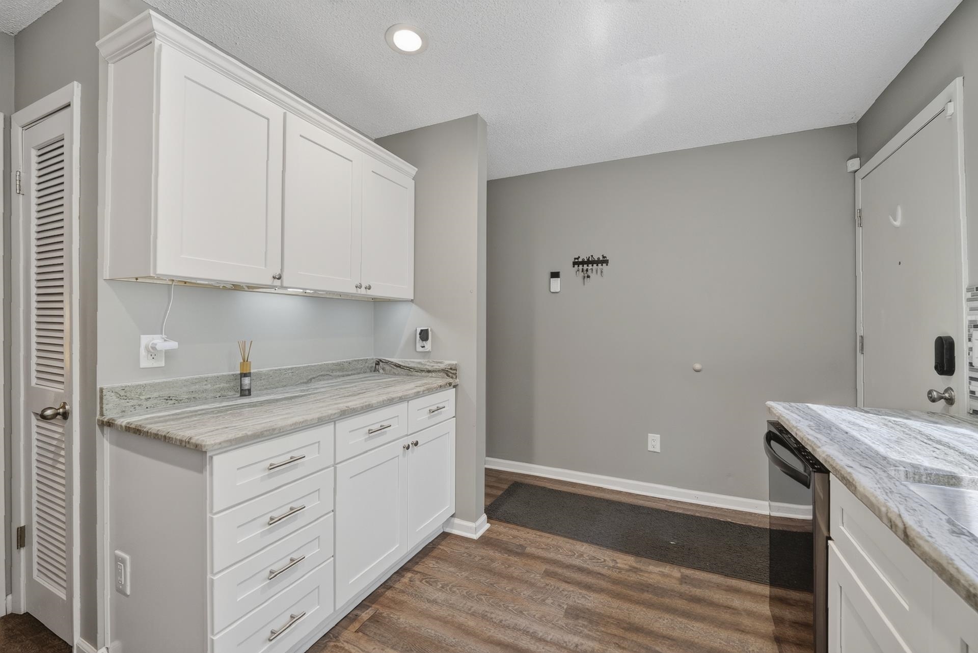 74 Driftwood Road Counce, TN 38326 - Photo 8 of 40 White shaker cabinetry with crown molding, under-cabinet lighting, and light-toned granite countertops