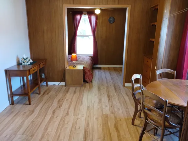 a view of a dining room with furniture and window