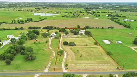 an aerial view of residential houses with outdoor space and river