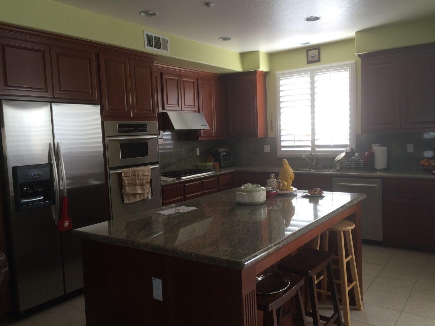 6193 Yardley Lane San Ramon, CA 94582 - Photo 1 of 1 a kitchen with a sink a kitchen island and stainless steel appliances