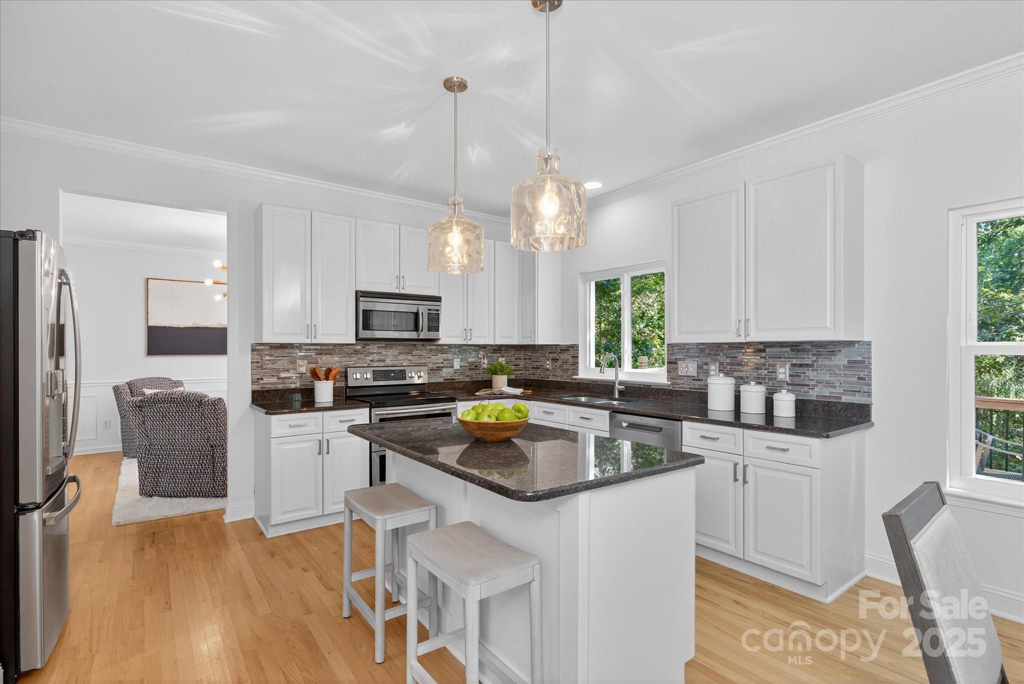 209 Whitegrove Drive Fort Mill, SC 29715 - Photo 11 of 48 a kitchen with a refrigerator a stove a microwave oven a sink dishwasher and white cabinets with wooden floor