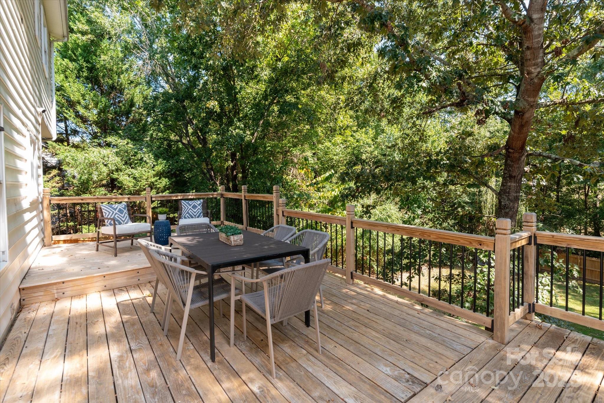 209 Whitegrove Drive Fort Mill, SC 29715 - Photo 16 of 48 a balcony with wooden floor table and chairs