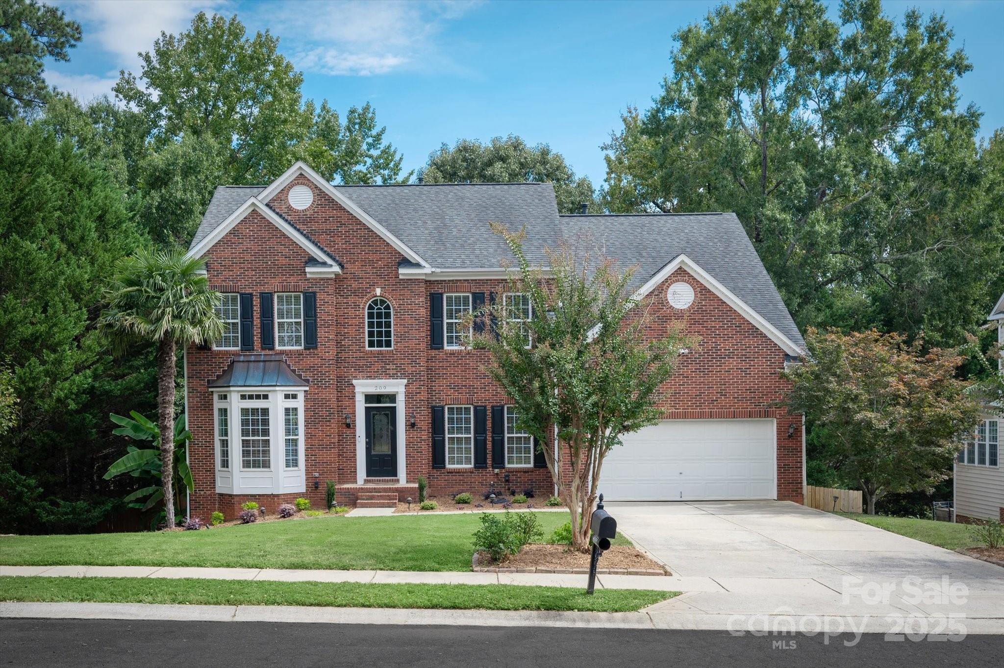 209 Whitegrove Drive Fort Mill, SC 29715 - Photo 2 of 48 a front view of a house with a yard and garage