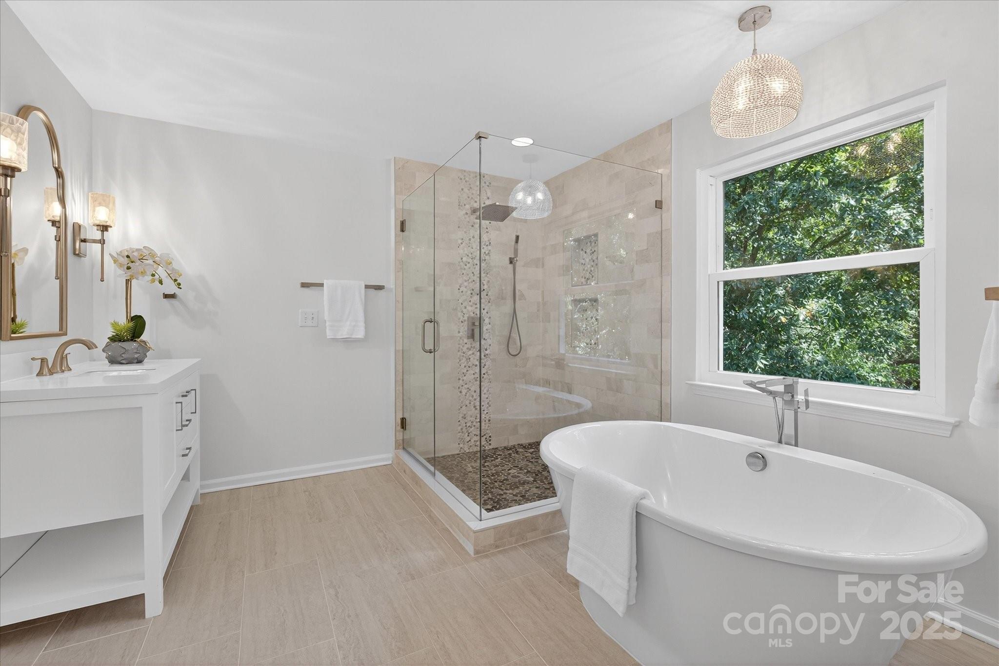 209 Whitegrove Drive Fort Mill, SC 29715 - Photo 27 of 48 a bathroom with a bathtub a sink a window and a shower