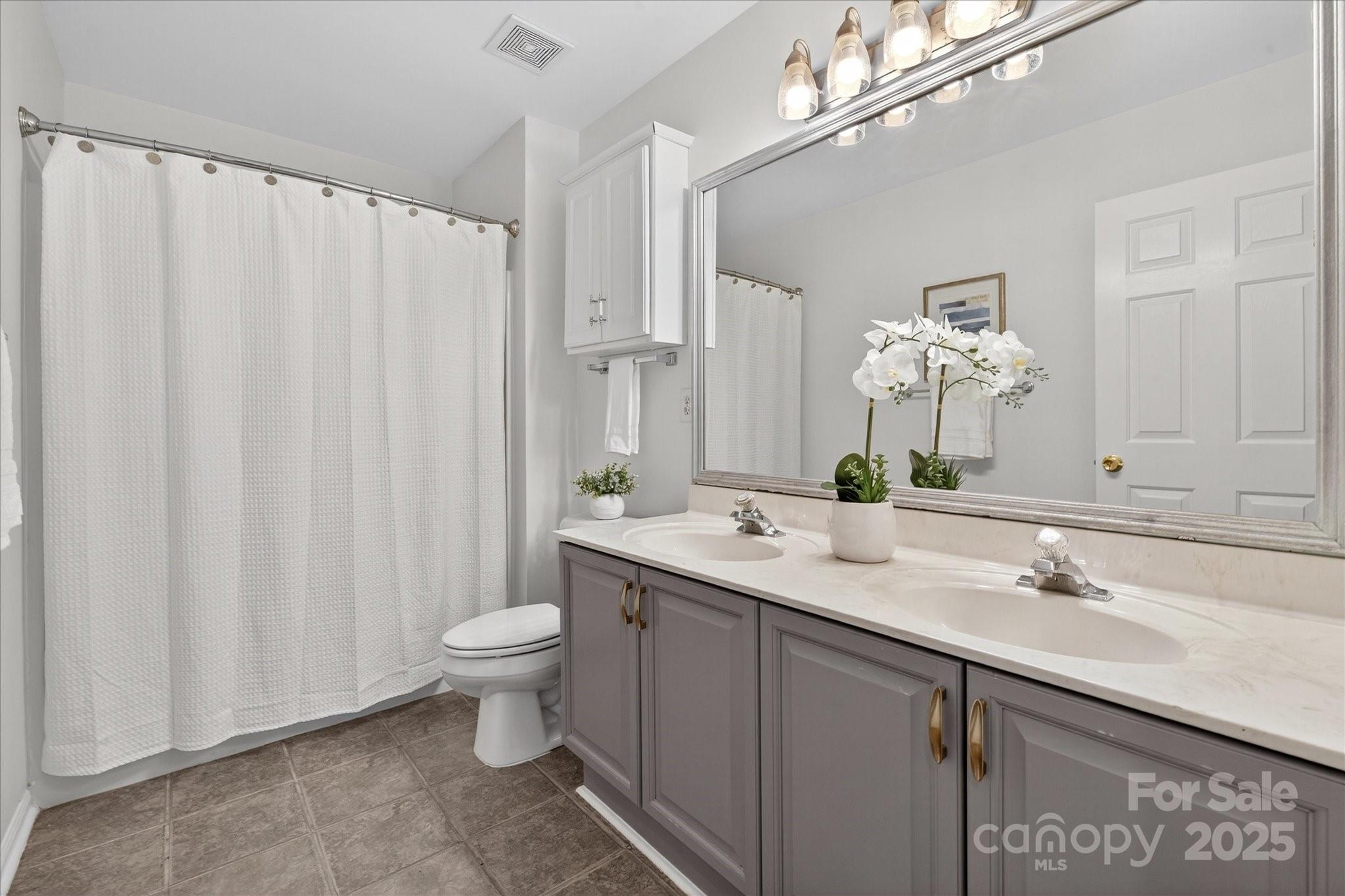 209 Whitegrove Drive Fort Mill, SC 29715 - Photo 29 of 48 a bathroom with a double vanity sink mirror and toilet