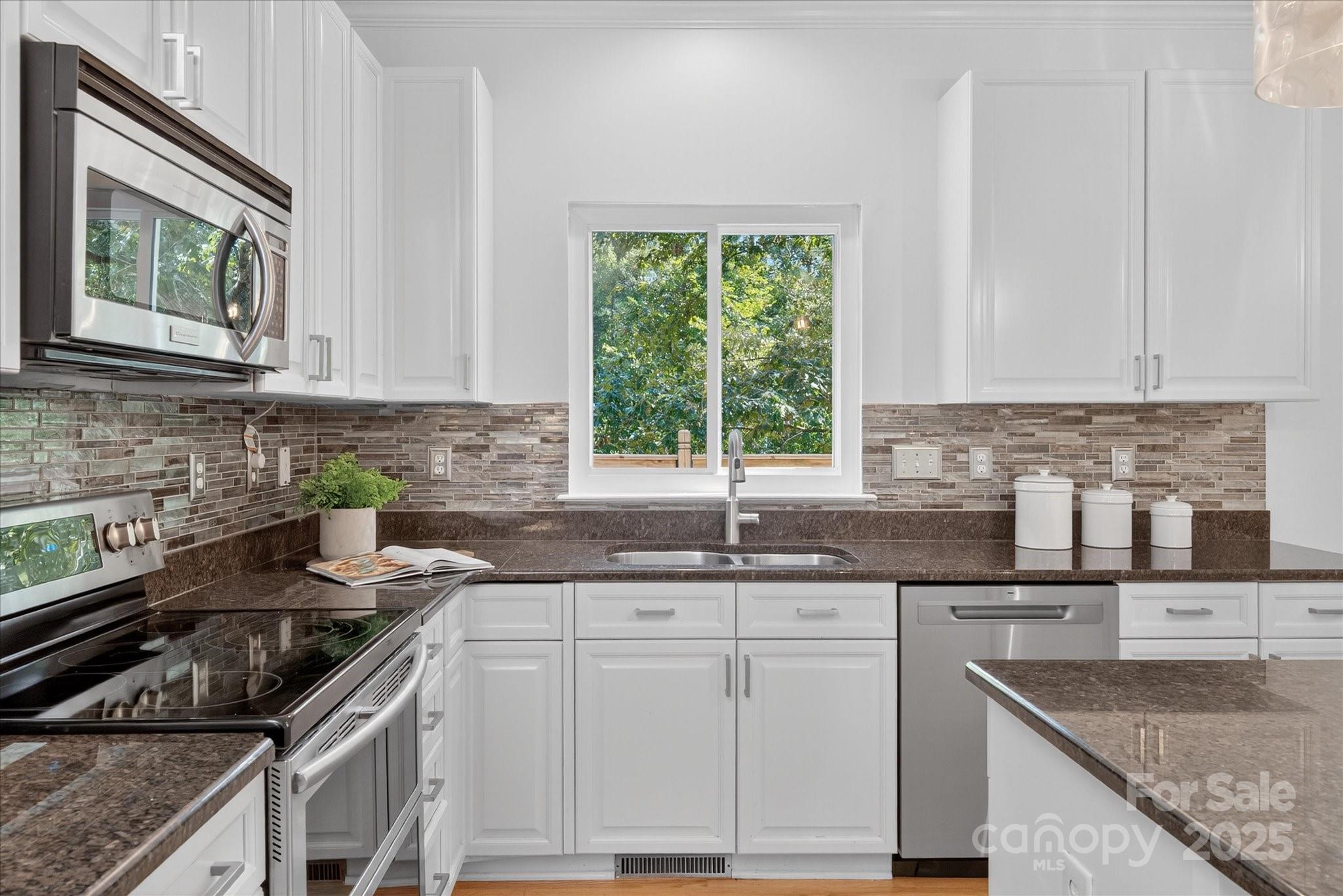 209 Whitegrove Drive Fort Mill, SC 29715 - Photo 10 of 48 a kitchen with granite countertop a sink stove and cabinets