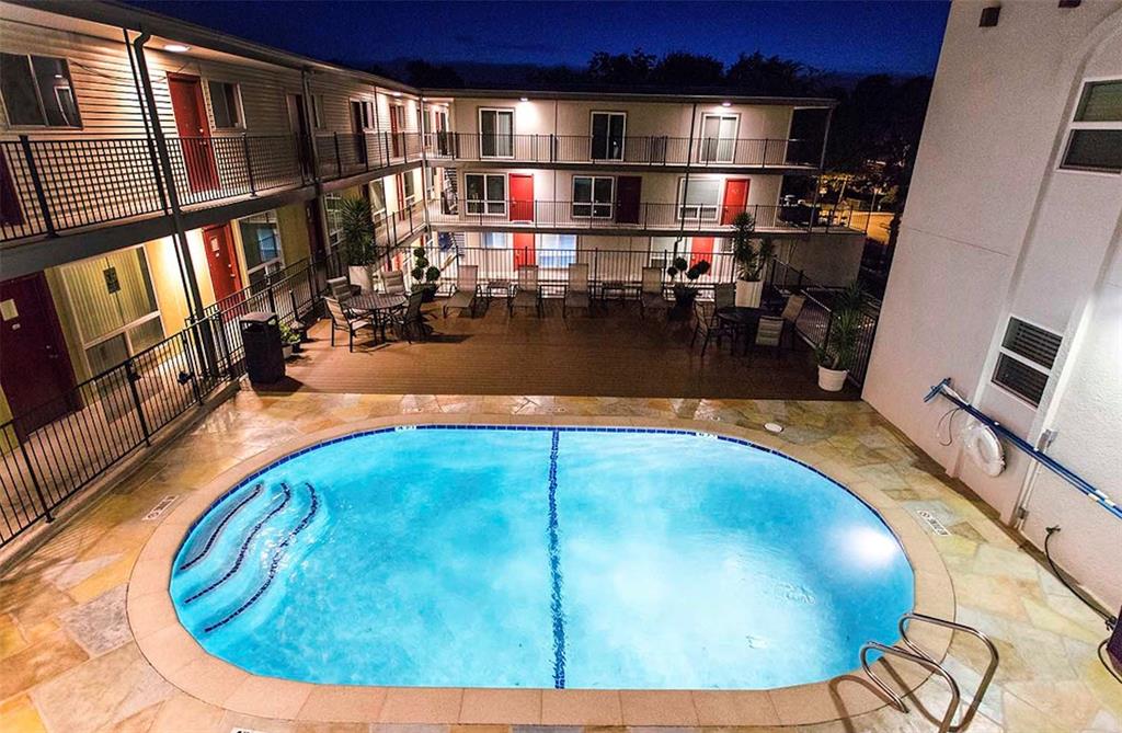 3110 Red River Street, Unit 116 Austin, TX 78705 - Photo 8 of 8 Pool at night featuring a community pool