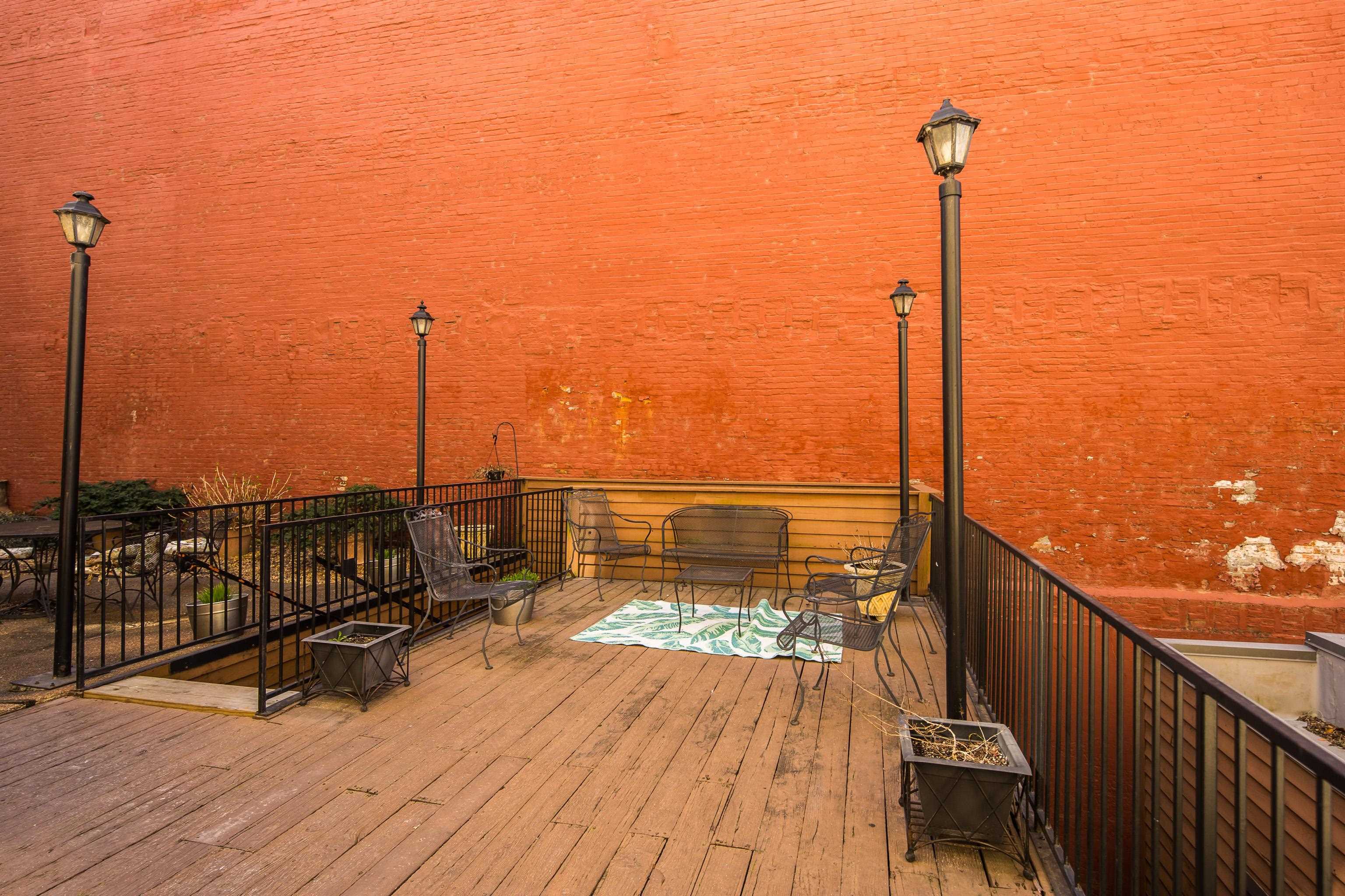 107 South Front Street, Unit 45 Memphis, TN 38103 - Photo 11 of 40 a view of a balcony with wooden floor with iron fence