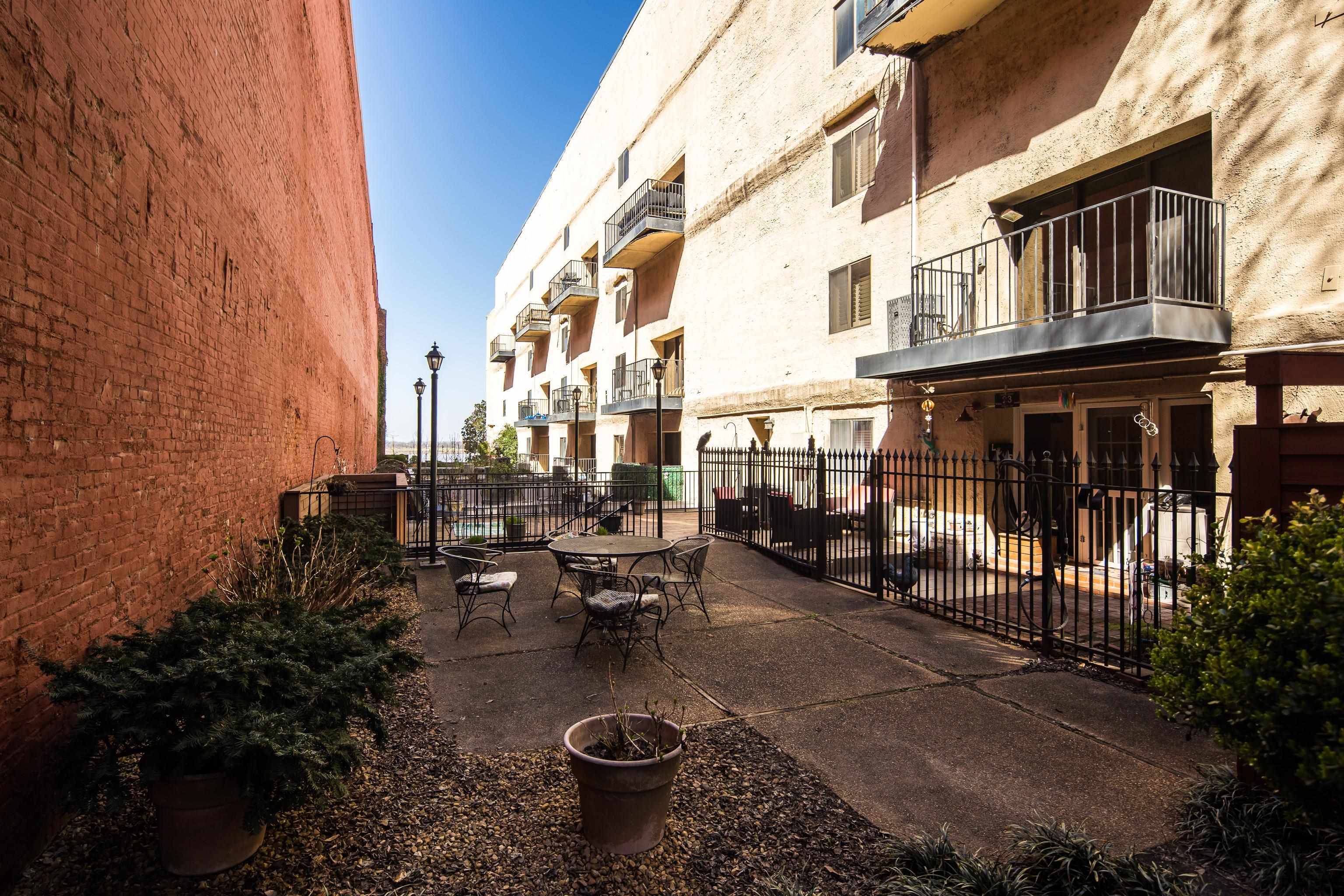 107 South Front Street, Unit 45 Memphis, TN 38103 - Photo 13 of 40 a view of a patio with table and chairs and potted plants