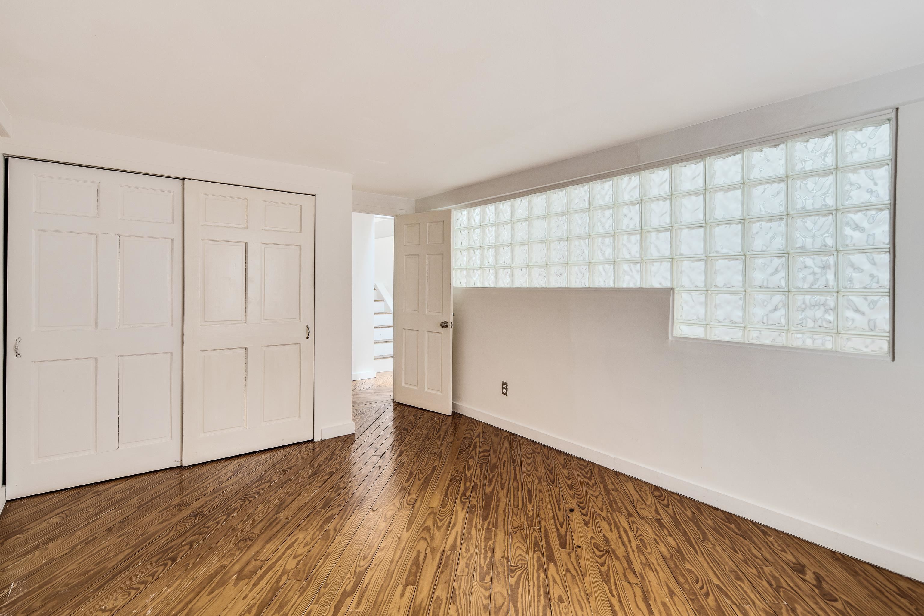 107 South Front Street, Unit 45 Memphis, TN 38103 - Photo 2 of 40 a view of an empty room with wooden floor and closet